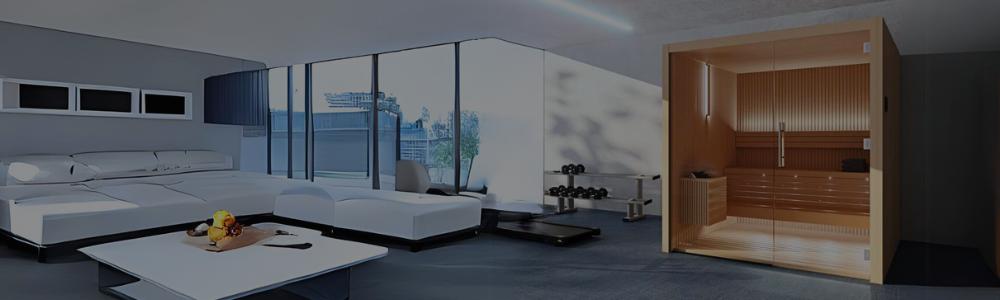 An Auroom Emma Glass indoor cabin sauna with a full glass front wall, set inside a modern home gym and lounge space.