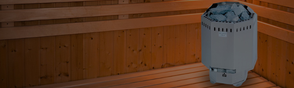 A gray Saunacore Elite sauna heater filled with stones, sitting inside a wooden sauna room.
