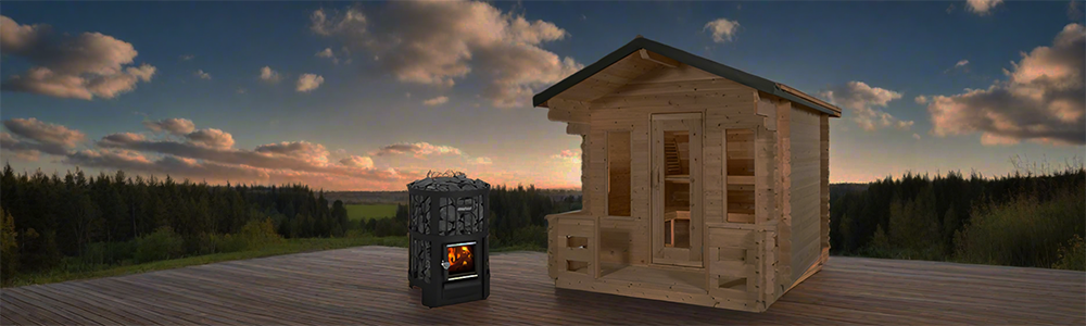 Premium outdoor cabin sauna and wood-burning stove on a deck at sunset.