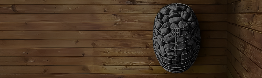 An oval-shaped HUUM sauna heater filled with stones, mounted on a horizontal wooden plank wall.