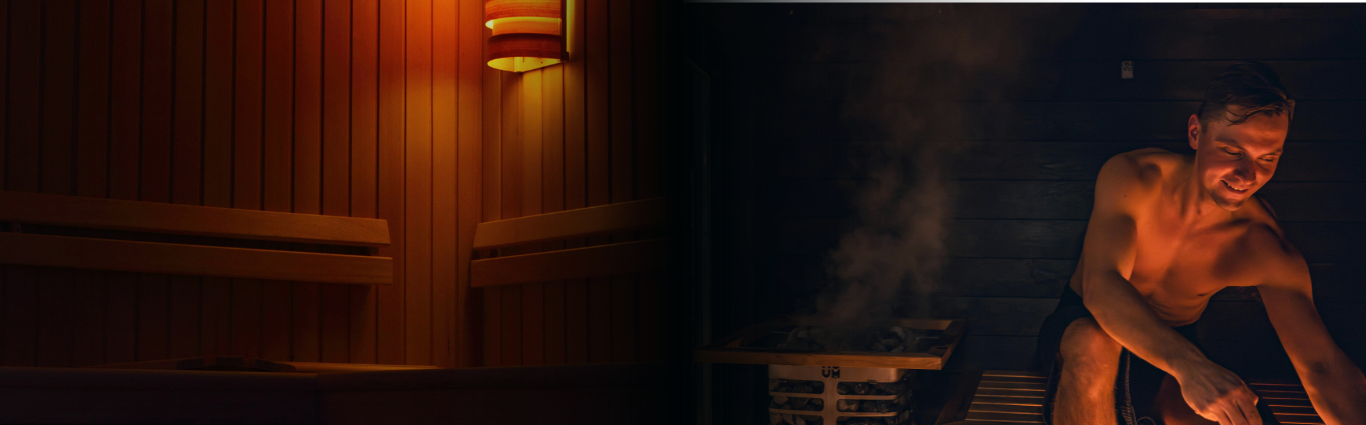 ark sauna interior with a man seated inside, surrounded by warm wooden walls and a calm, low-lit atmosphere.