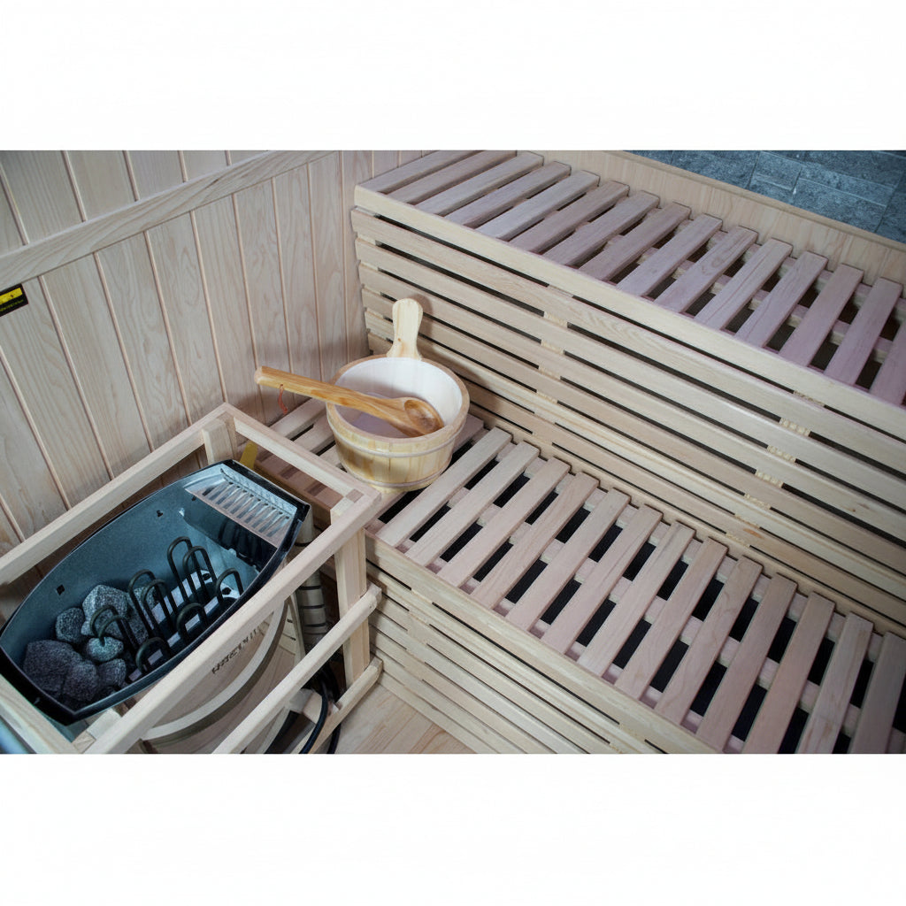 A wooden sauna interior with slatted benches, a hanging black sauna stove, a wooden bowl, and a wooden spoon.