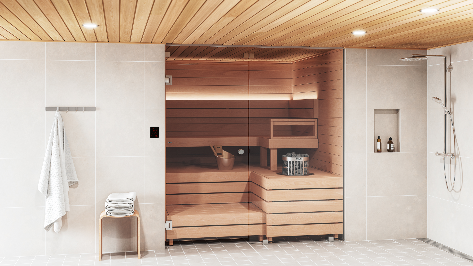 A modern wooden sauna room with a glass door, set inside a tiled bathroom with a wooden slatted ceiling, a small towel rack with a white towel, and a shower area to the right.