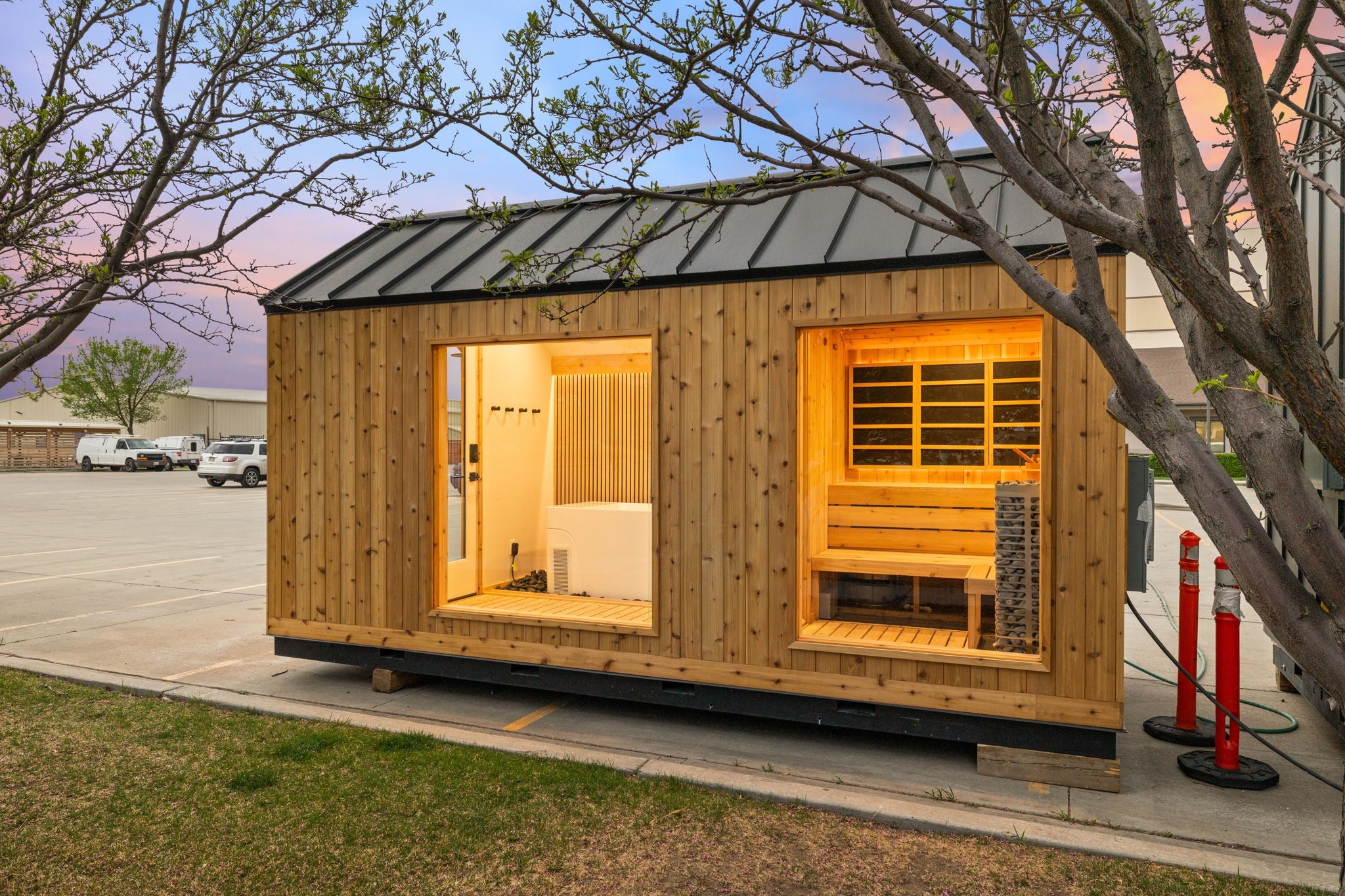 Sweaty Yeti 4-6 Person Outdoor Sauna & Cold Plunge Cabin with trees in the background.