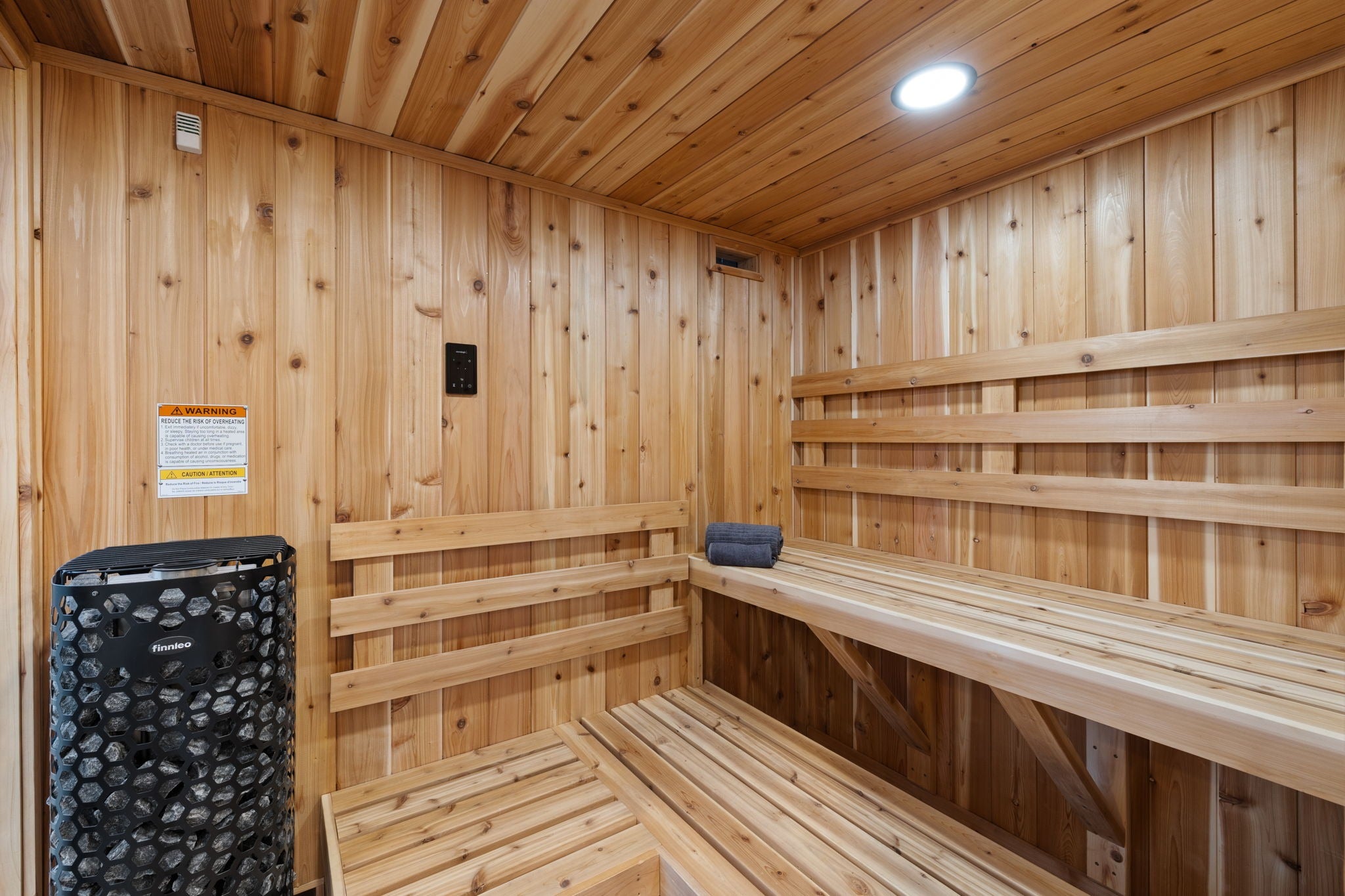 Wooden sauna with benches and a heater