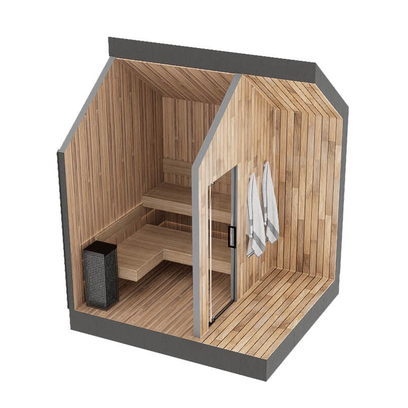 A modern wooden sauna cabin with light natural wood plank walls, benches, and floor, dark gray exterior framing, a glass door, hanging white towels, and a black sauna heater on a plain white background.