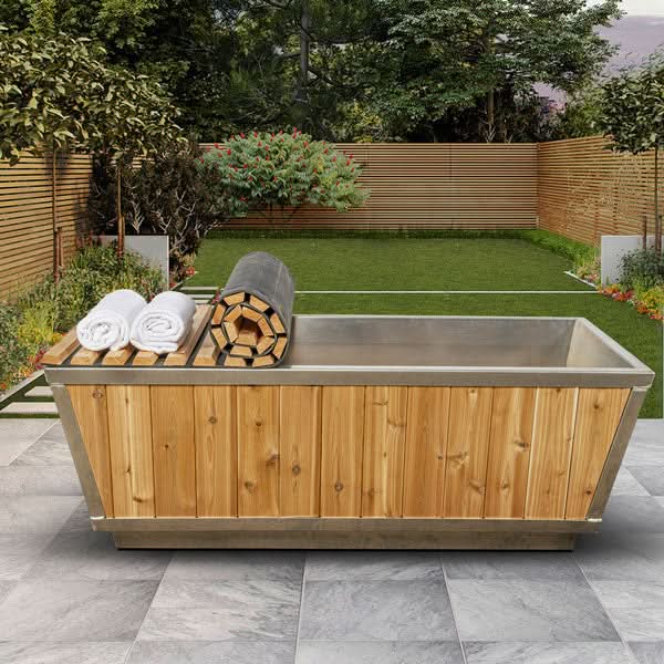 Dundalk LeisureCraft Glacier cold plunge tub in knotty red cedar on a backyard patio