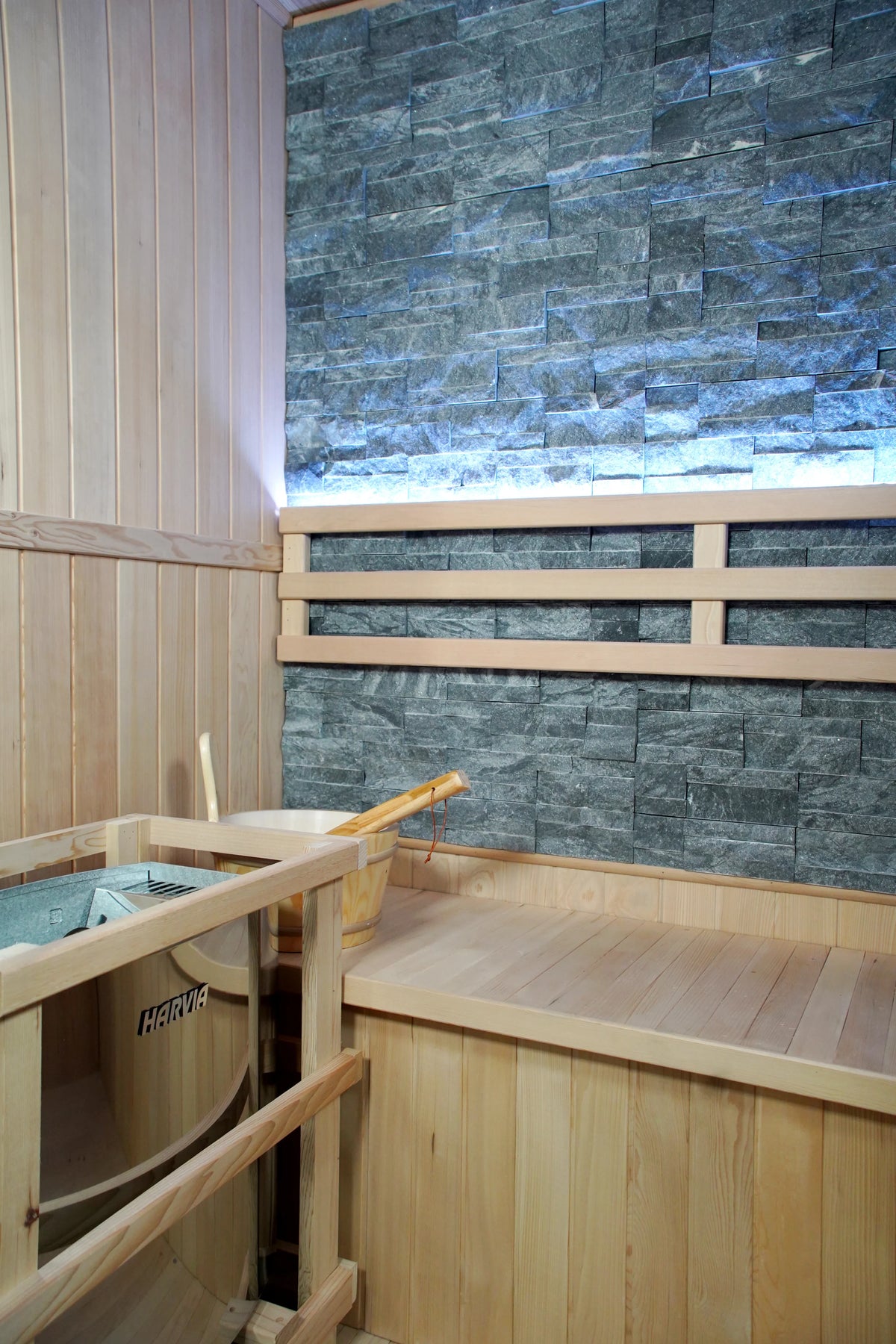 Westlake corner with heater guard, wooden bucket and backlit stone wall