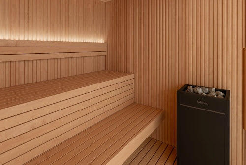 Wooden sauna interior with benches and black sauna heater.