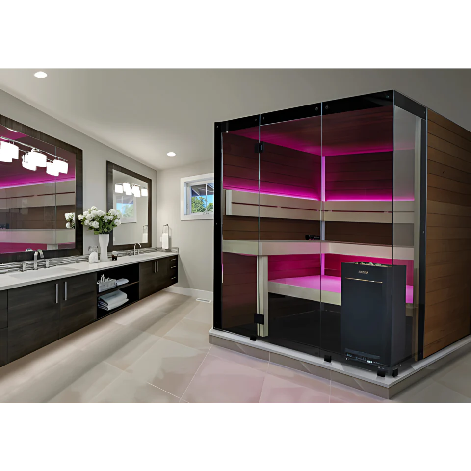 A modern double bed spa or sauna cabin with glass walls, dark wood interior panels, and bright pink ambient lighting, shown in a bathroom setting next to a double vanity.