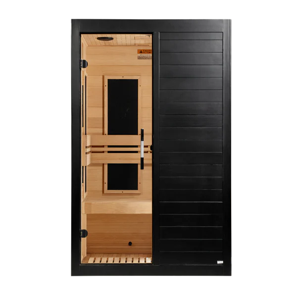 A modern single-room infrared sauna with a black exterior door and light natural wood interior shelves and walls, shown against a plain white background.