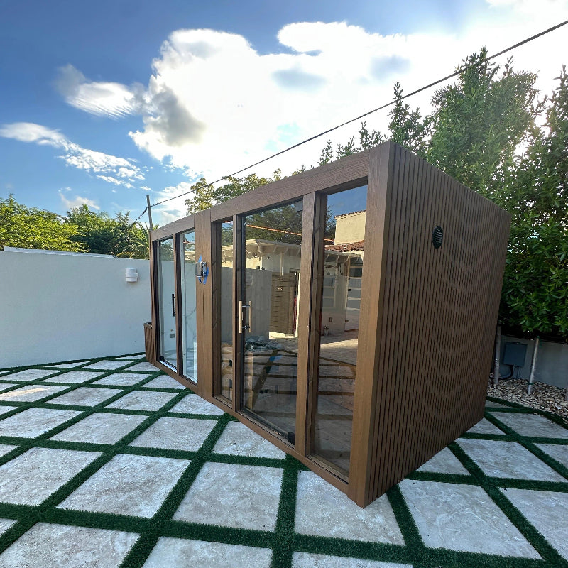 Modular building with glass walls on a checkered green and white patio