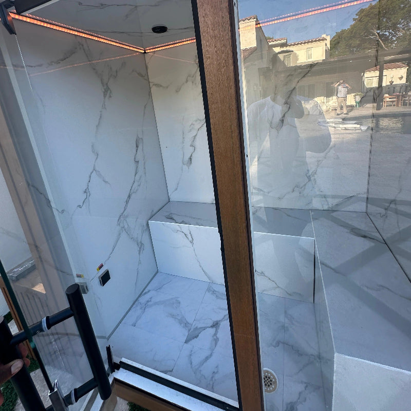 Marble-patterned shower enclosure with glass door -GeyserSteam_Nova