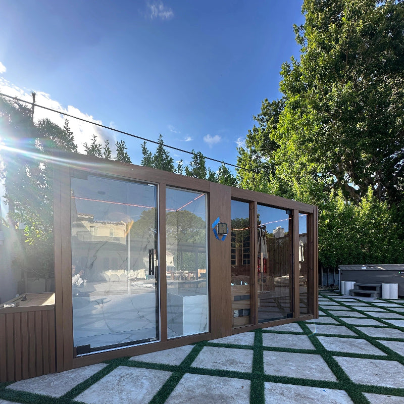 Premium outdoor sauna with expansive glass windows and a sleek backyard design.