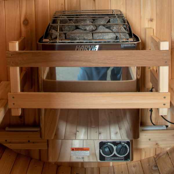 Almost Heaven heater guard installed around a Harvia heater in a barrel sauna
