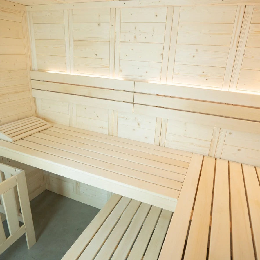 Wooden sauna interior with benches and walls.