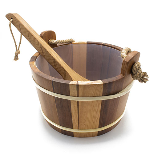 Wooden bucket with handles and a ladle on a white background