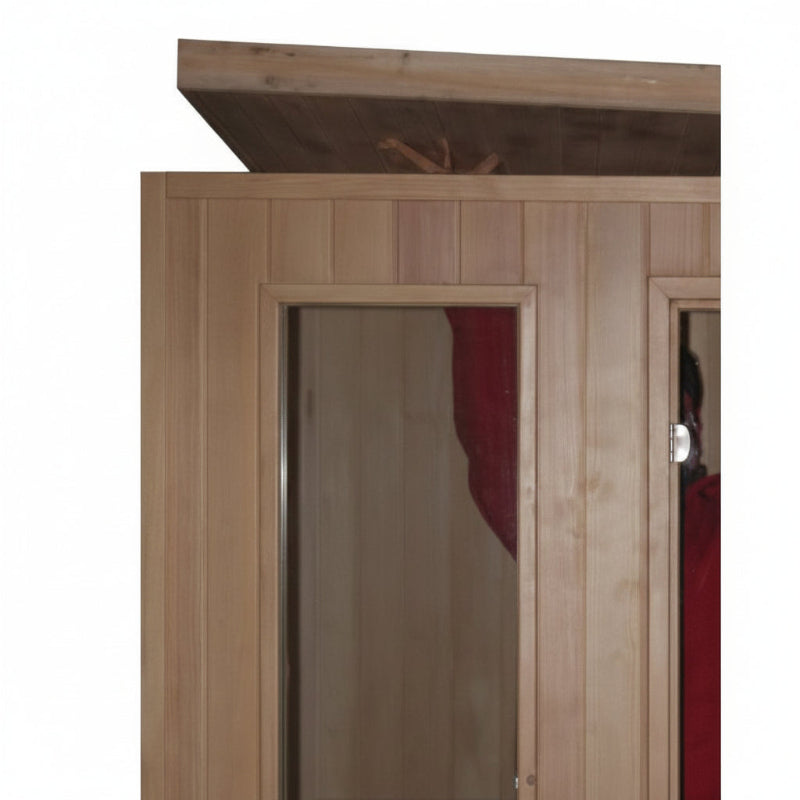 Wooden sauna cabin with light natural wood paneling, a dark wooden roof overhang, and glass doors showing a red interior lining.