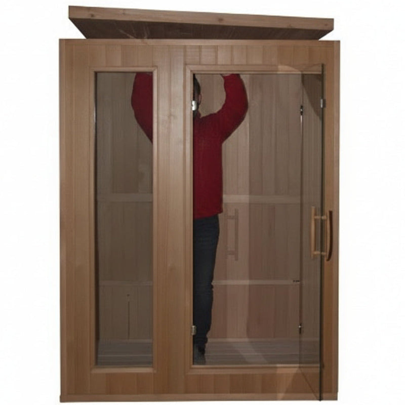 A wooden double-door sauna with glass panels, showing a person standing inside on a white background.