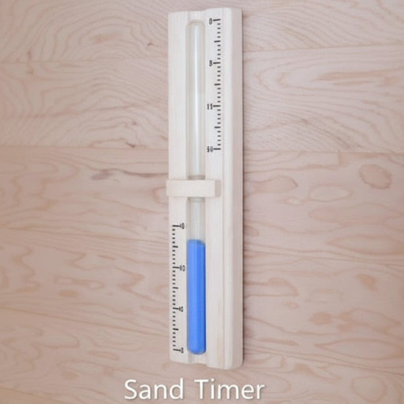 A vertical sand timer with a white plastic casing and a blue sand-filled chamber, shown against a light wood grain background. The text 'Sand Timer' is written below the product.