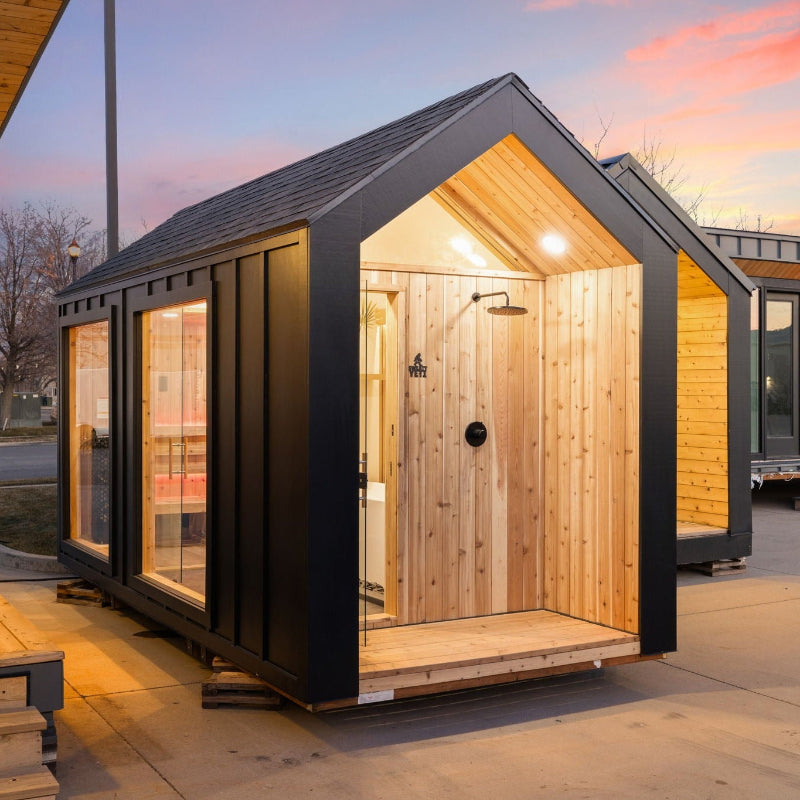 Sweaty Yeti 4-6-Person Outdoor Sauna & Cold Plunge Cabin against a sunset background.
