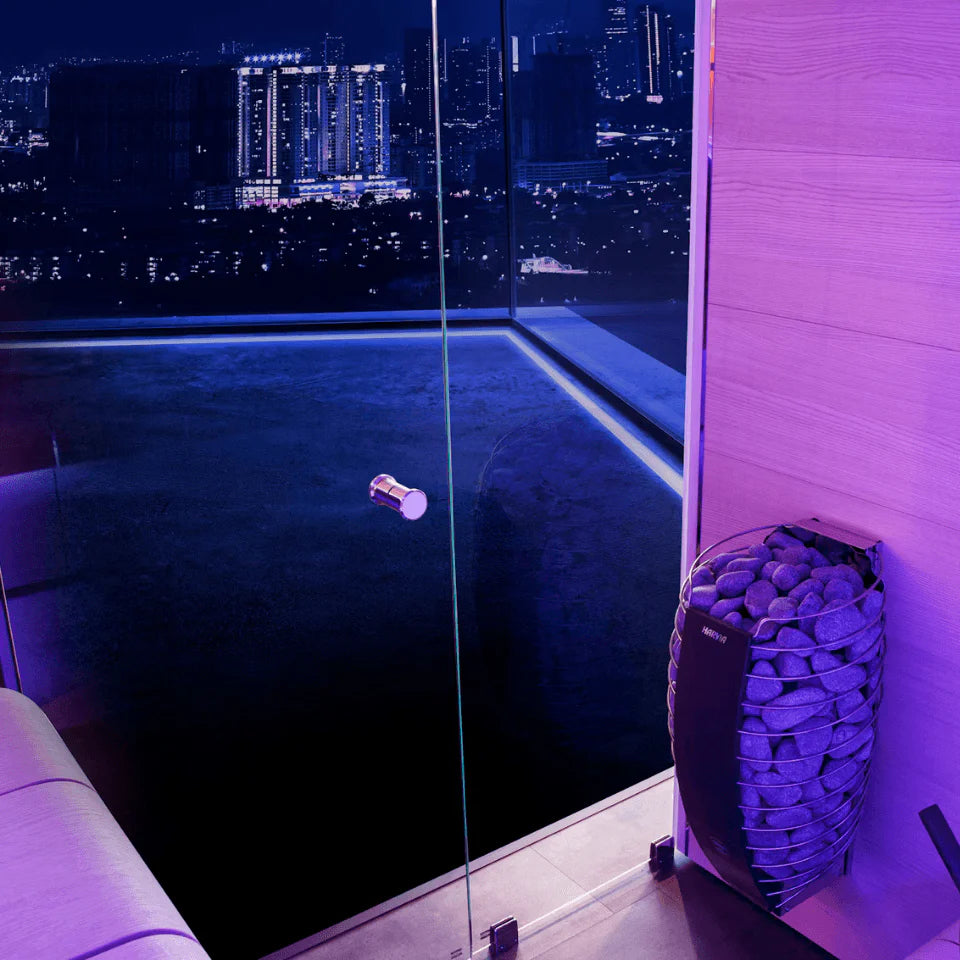 Modern indoor pool with city skyline view at night