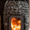 Wood-burning sauna heater with visible flames inside a traditional sauna.