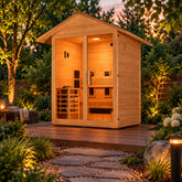 Golden Designs Carinthia gable roof hybrid sauna on a garden deck at dusk